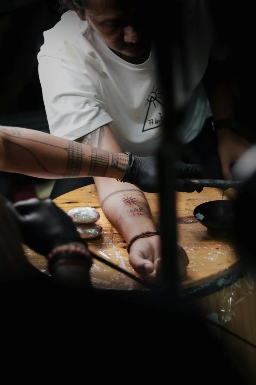 Sak Yant tattooing process, traditional bamboo rod technique Bangkok